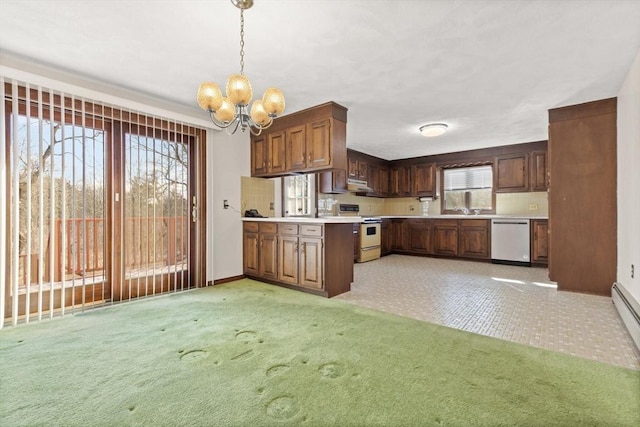 11 Ocean View Dr, Gloucester, MA 01930 - kitchen with dishwasher, white range, light countertops, a chandelier, and plenty of natural light