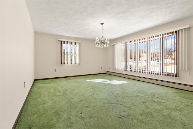 11 Ocean View Dr, Gloucester, MA 01930 - carpeted spare room with plenty of natural light, a baseboard heating unit, a chandelier, baseboards, and a textured ceiling