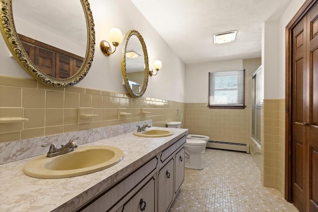 11 Ocean View Dr, Gloucester, MA 01930 - bathroom with a baseboard heating unit, tile walls, toilet, wainscoting, and tile patterned flooring
