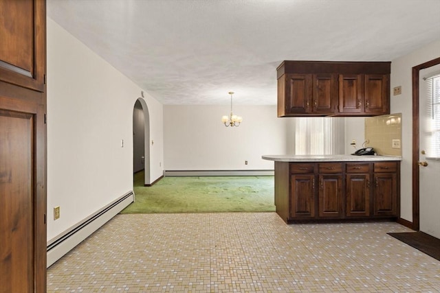 11 Ocean View Dr, Gloucester, MA 01930 - kitchen with baseboard heating, light carpet, arched walkways, and light countertops