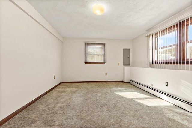 11 Ocean View Dr, Gloucester, MA 01930 - spare room featuring a baseboard heating unit, healthy amount of natural light, carpet, electric panel, and a textured ceiling