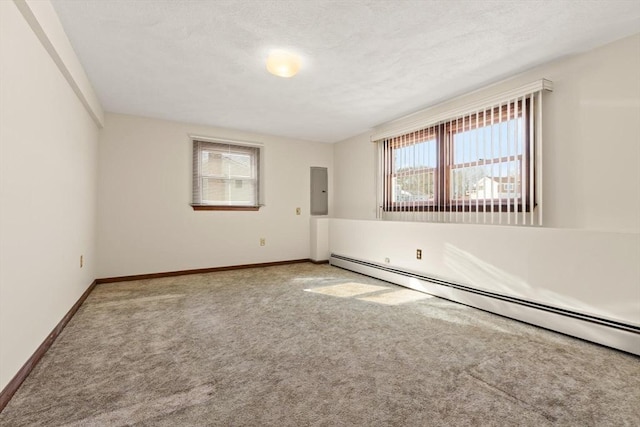 11 Ocean View Dr, Gloucester, MA 01930 - carpeted empty room featuring baseboard heating, baseboards, a textured ceiling, and electric panel