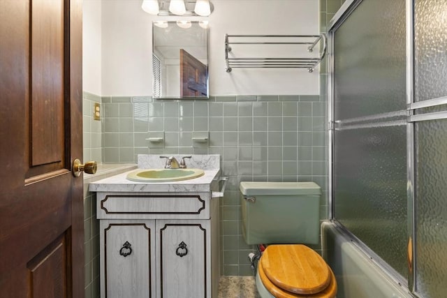 11 Ocean View Dr, Gloucester, MA 01930 - bathroom with tile walls, toilet, vanity, enclosed tub / shower combo, and wainscoting
