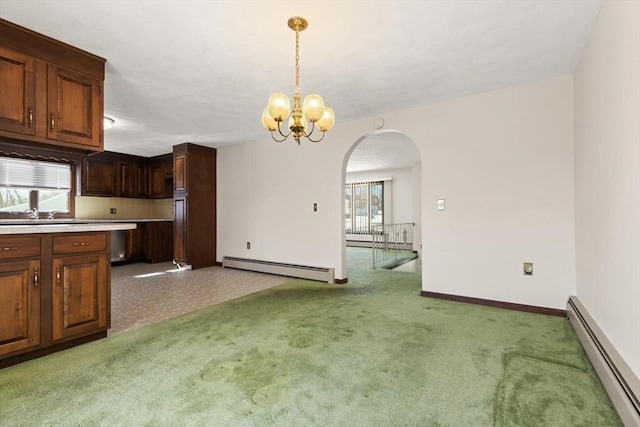 11 Ocean View Dr, Gloucester, MA 01930 - kitchen featuring baseboard heating, arched walkways, light countertops, and light colored carpet
