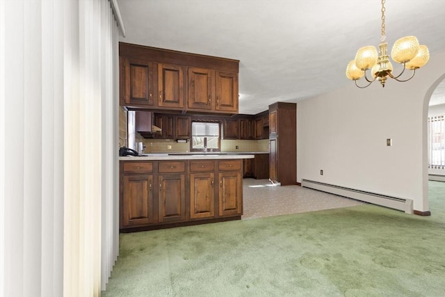 11 Ocean View Dr, Gloucester, MA 01930 - kitchen featuring a baseboard heating unit, arched walkways, a chandelier, light countertops, and decorative light fixtures