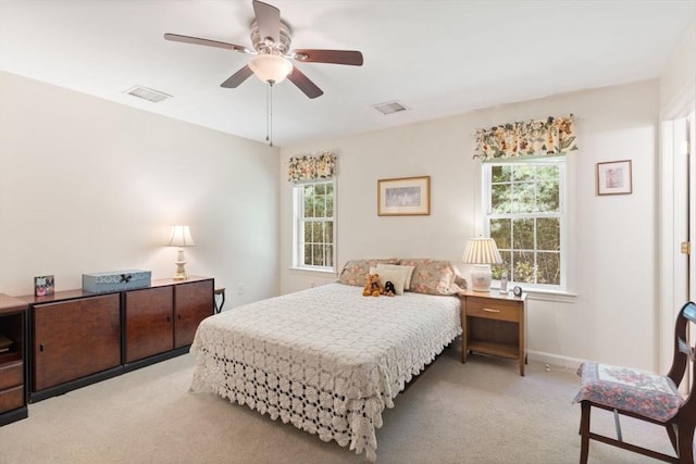 carpeted bedroom featuring multiple windows, baseboards, and ceiling fan