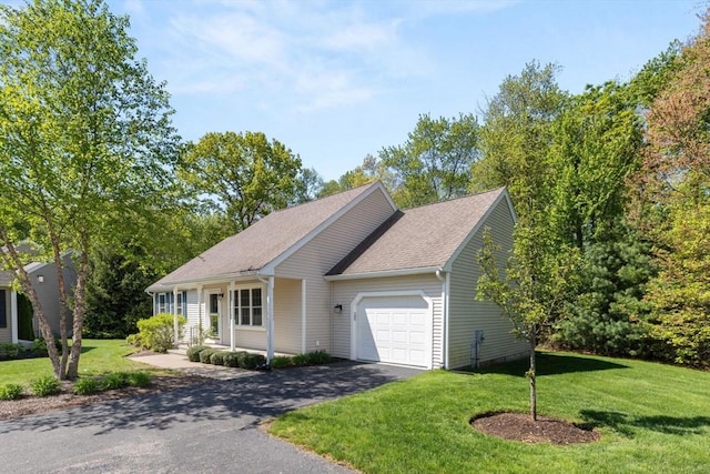 single story home with a garage, asphalt driveway, a front lawn, and roof with shingles