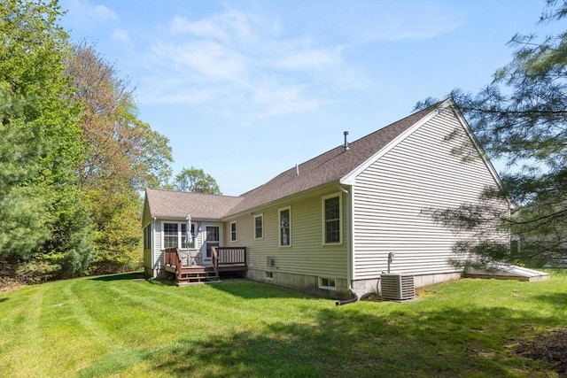 back of house with a wooden deck, a lawn, and cooling unit