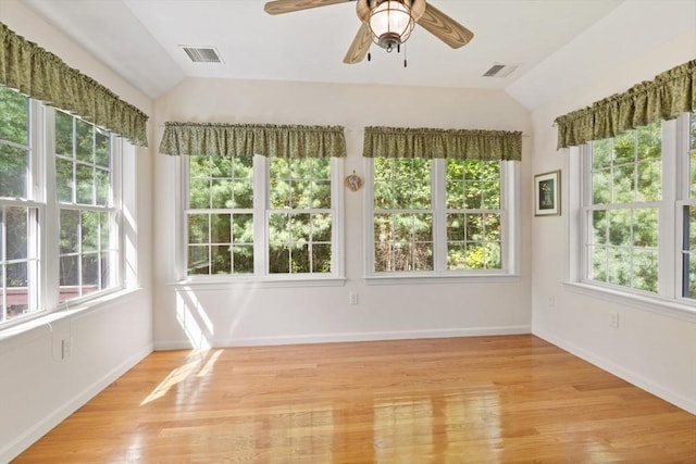 unfurnished sunroom featuring vaulted ceiling