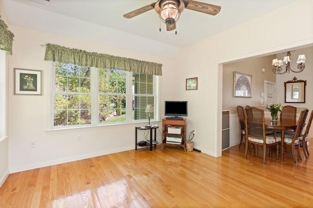 dining area featuring light wood-style flooring, ceiling fan, baseboards, and lofted ceiling