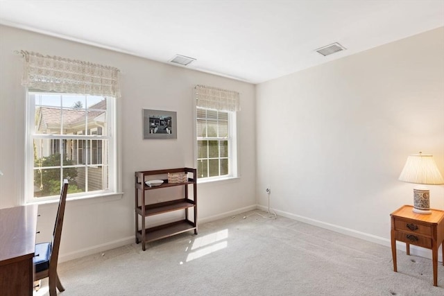 sitting room featuring carpet, healthy amount of natural light, and baseboards