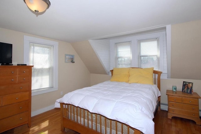 1243 Main St Unit 1243, Barnstable, MA 02635 - bedroom with baseboard heating, baseboards, wood finished floors, and lofted ceiling