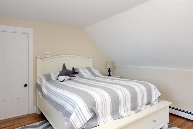 1243 Main St Unit 1243, Barnstable, MA 02635 - bedroom with vaulted ceiling, wood finished floors, and baseboard heating