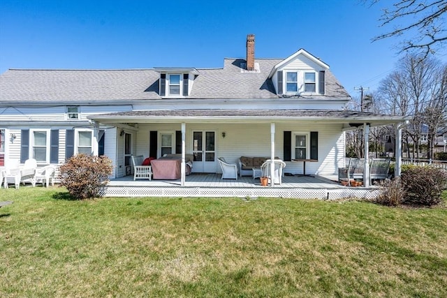 1243 Main St Unit 1243, Barnstable, MA 02635 - rear view of property with a chimney, a yard, and roof with shingles