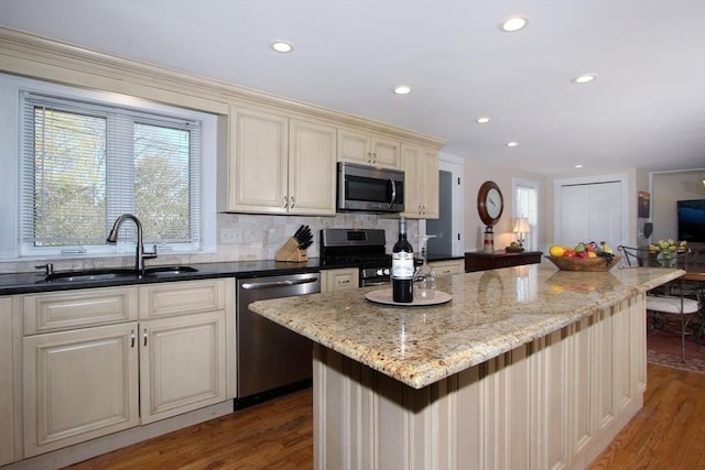 1243 Main St Unit 1243, Barnstable, MA 02635 - kitchen with a sink, stainless steel appliances, cream cabinetry, recessed lighting, and a wealth of natural light