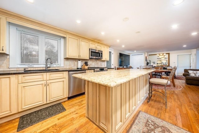 1243 Main St Unit 1243, Barnstable, MA 02635 - kitchen with cream cabinets, open floor plan, appliances with stainless steel finishes, and a sink