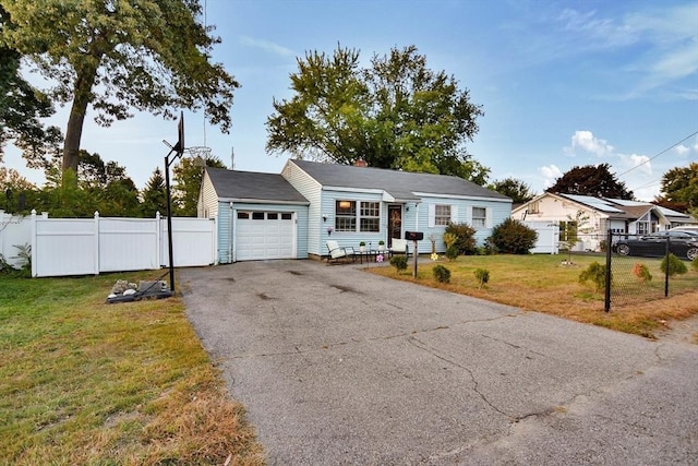 ranch-style home featuring a garage and driveway