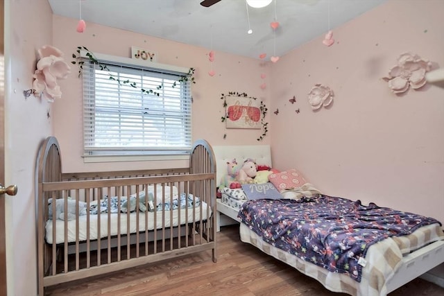 bedroom featuring wood finished floors and a ceiling fan
