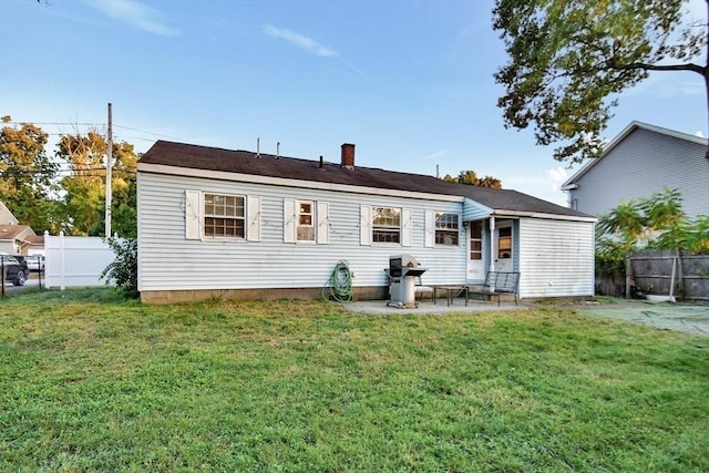 rear view of property with a patio and a chimney
