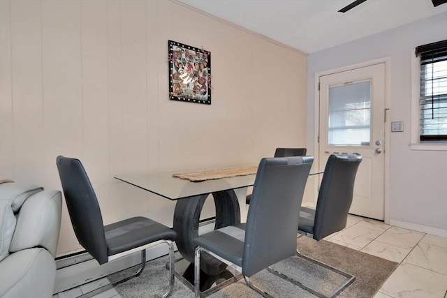 dining area with light marble finish floors and baseboards