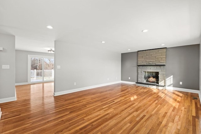 unfurnished living room with a fireplace and light hardwood / wood-style flooring