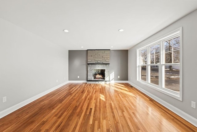 unfurnished living room featuring hardwood / wood-style floors and a fireplace