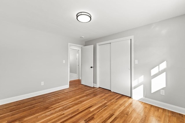 unfurnished bedroom featuring light hardwood / wood-style floors and a closet