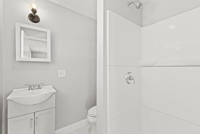 bathroom with walk in shower, vanity, and toilet