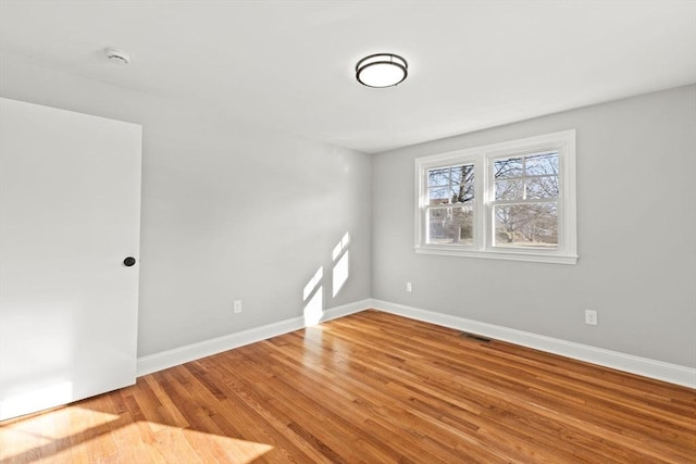 spare room featuring hardwood / wood-style flooring