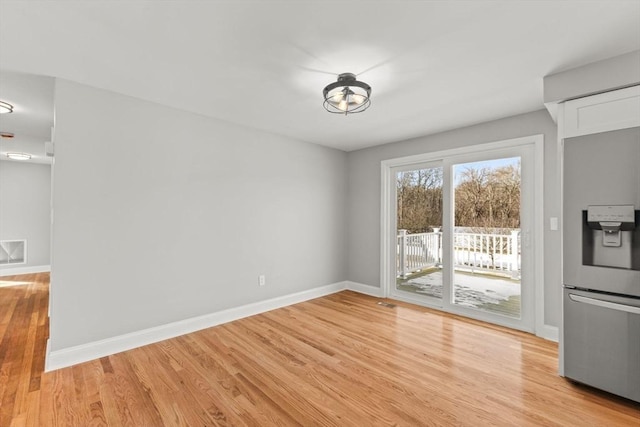 unfurnished dining area with light hardwood / wood-style flooring