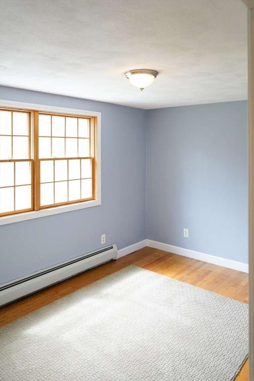 6 Sunrise, Auburn, MA 01501 - spare room featuring baseboard heating, baseboards, and wood finished floors