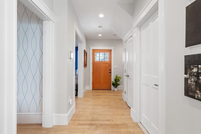 doorway with recessed lighting, baseboards, and light wood finished floors