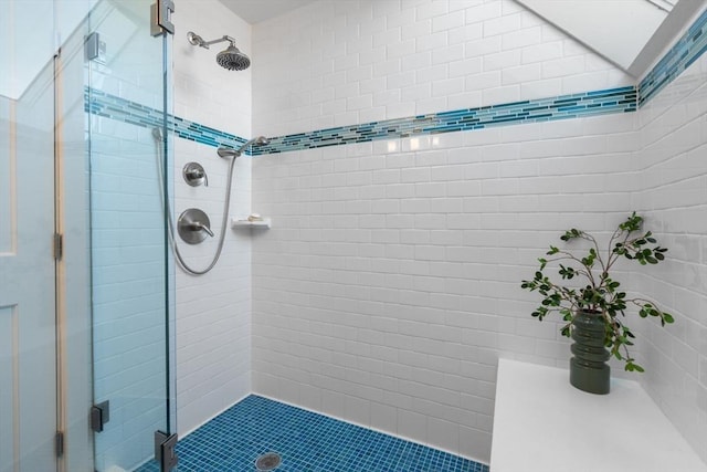 bathroom featuring lofted ceiling and a stall shower