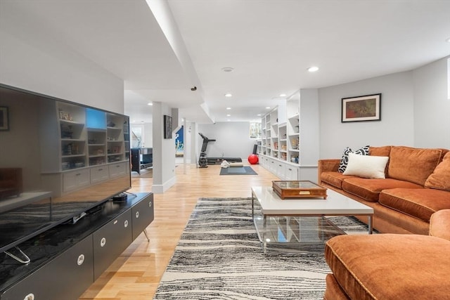 living area with baseboards, stairway, recessed lighting, and light wood-style floors