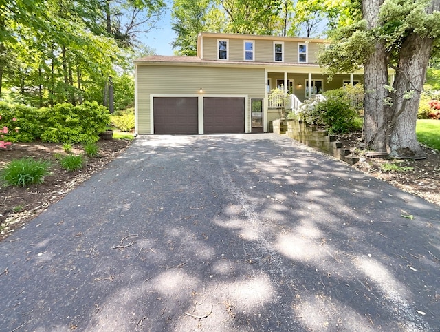 view of front of home with covered porch and a garage