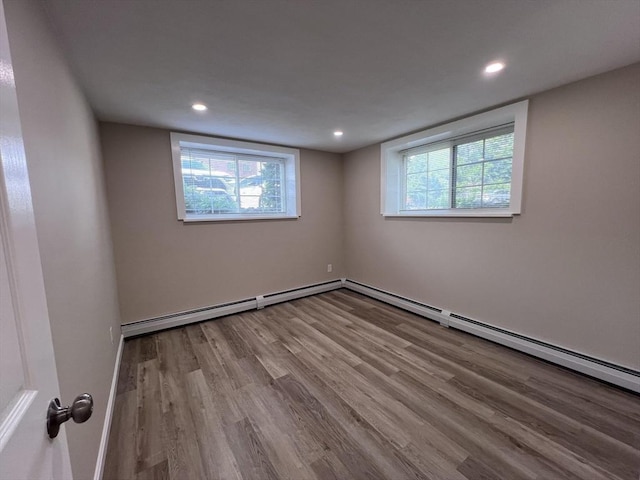 12 Woodland St Unit 12, Everett, MA 02149 - unfurnished room featuring wood finished floors, plenty of natural light, recessed lighting, a baseboard radiator, and baseboards