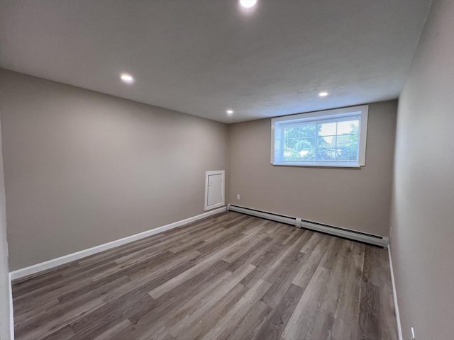 12 Woodland St Unit 12, Everett, MA 02149 - empty room with a baseboard radiator, wood finished floors, recessed lighting, and baseboards