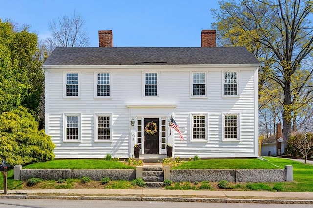 228 Main St, Groton, MA 01450 - colonial inspired home with a front lawn and a chimney