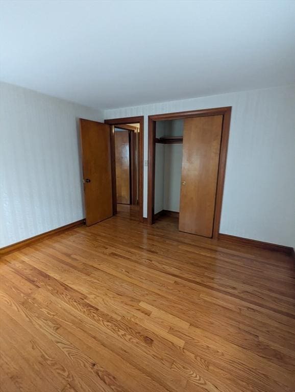 unfurnished bedroom featuring baseboards and light wood finished floors