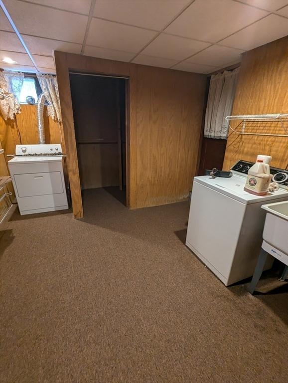 washroom featuring laundry area, wooden walls, independent washer and dryer, and carpet floors