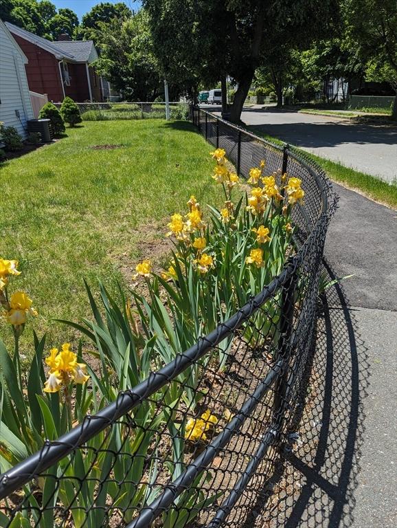 view of yard with fence and central AC