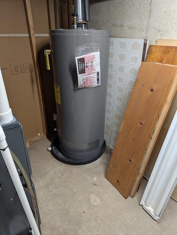 utility room featuring water heater