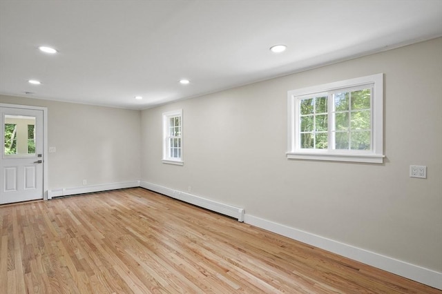 empty room featuring recessed lighting, light wood-type flooring, and baseboards