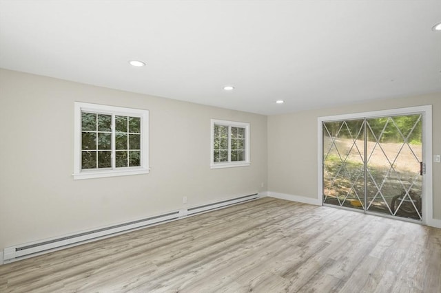 empty room with baseboards, a baseboard radiator, wood finished floors, and recessed lighting