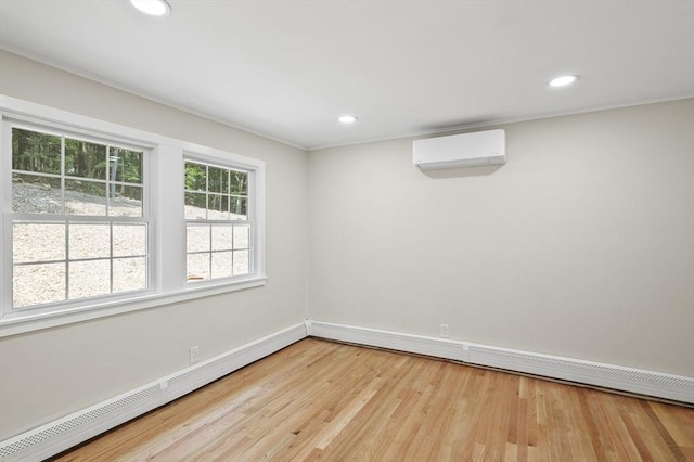 empty room with a baseboard radiator, an AC wall unit, recessed lighting, and wood finished floors