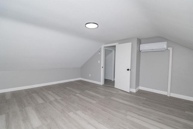 670 Putnam Pike, Smithfield, RI 02917 - additional living space with a wall unit AC, lofted ceiling, wood finished floors, and baseboards
