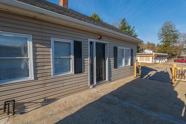 670 Putnam Pike, Smithfield, RI 02917 - view of side of property featuring a chimney and a patio area