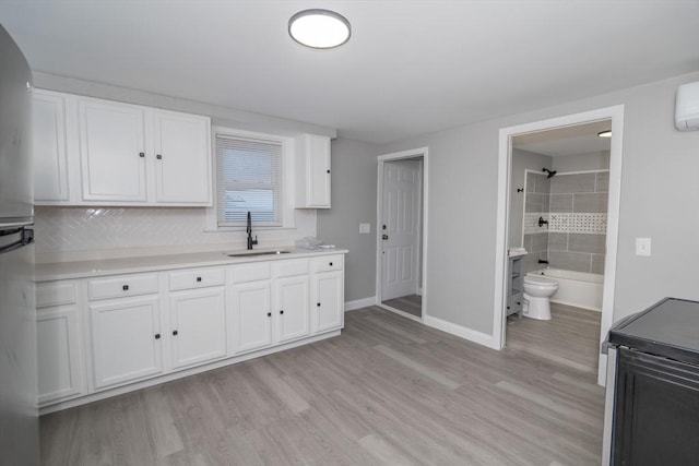 670 Putnam Pike, Smithfield, RI 02917 - kitchen with a sink, white cabinetry, baseboards, light wood-type flooring, and light countertops