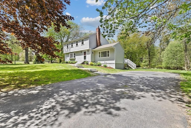 59 First Parish Rd, Norwell, MA 02061 - colonial-style house with a chimney and a front yard