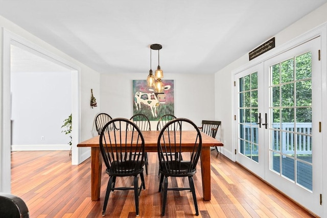 59 First Parish Rd, Norwell, MA 02061 - dining room featuring light wood-type flooring, a chandelier, and french doors